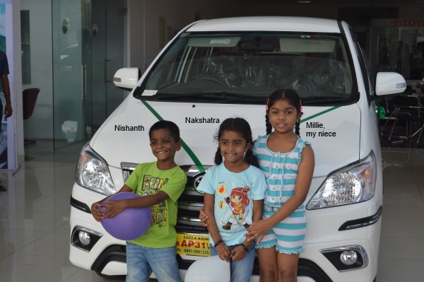 My kids and my niece infront our new car